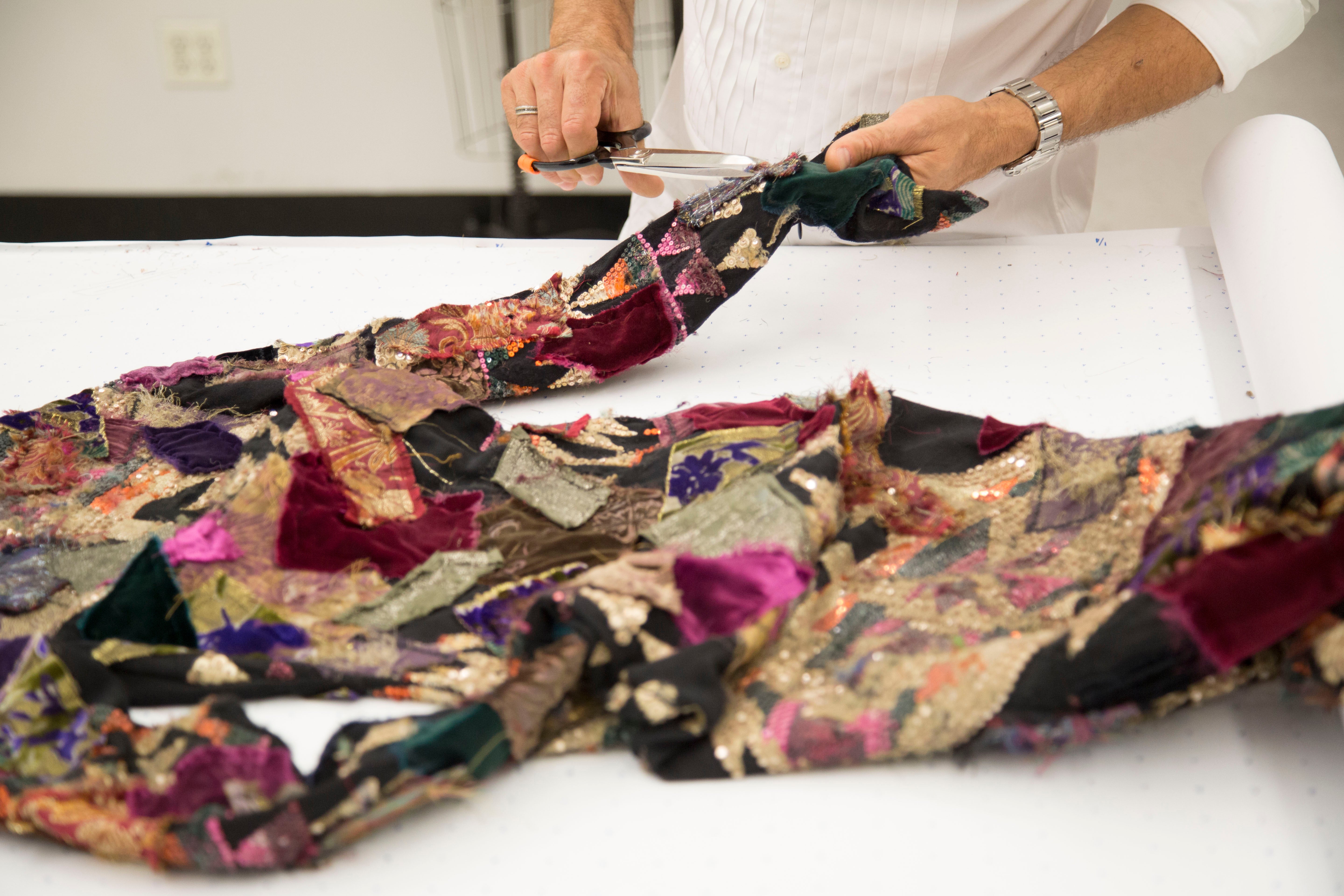 A skilled artisan works on the patchwork pattern of the Hamlin dress from the Ralph Lauren 50th Anniversary Collection